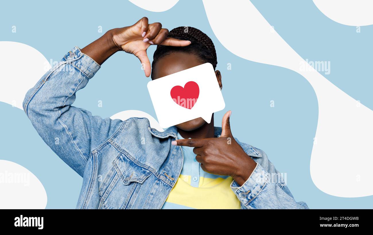 Woman holding heart card over face, gesturing frame with fingers Stock Photo