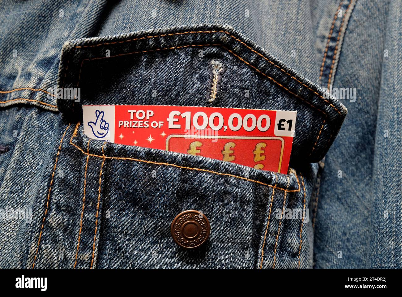 lottery £100,000 scratch card in denim jacket pocket Stock Photo Alamy
