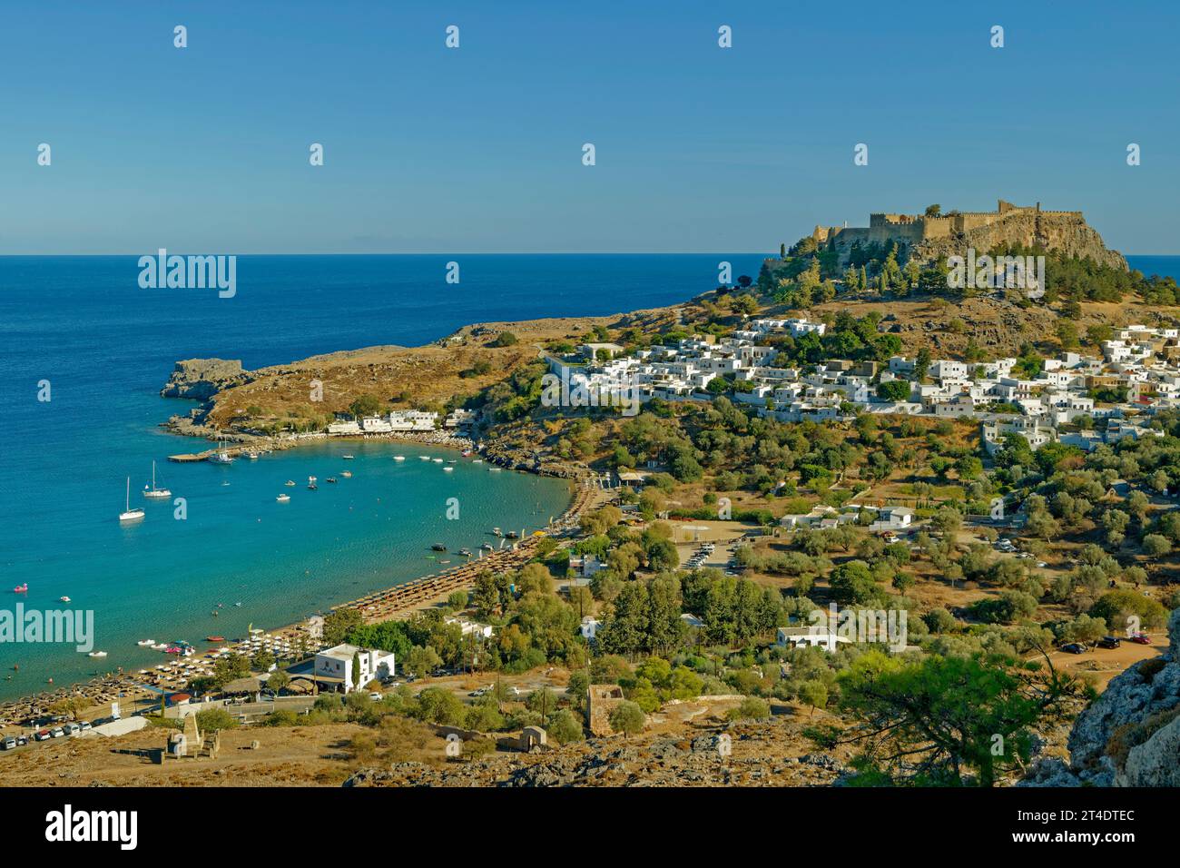 Lindos Rhodes Locals The town of Lindos on Rhodes island with the Lindos Acropolis on it's ...