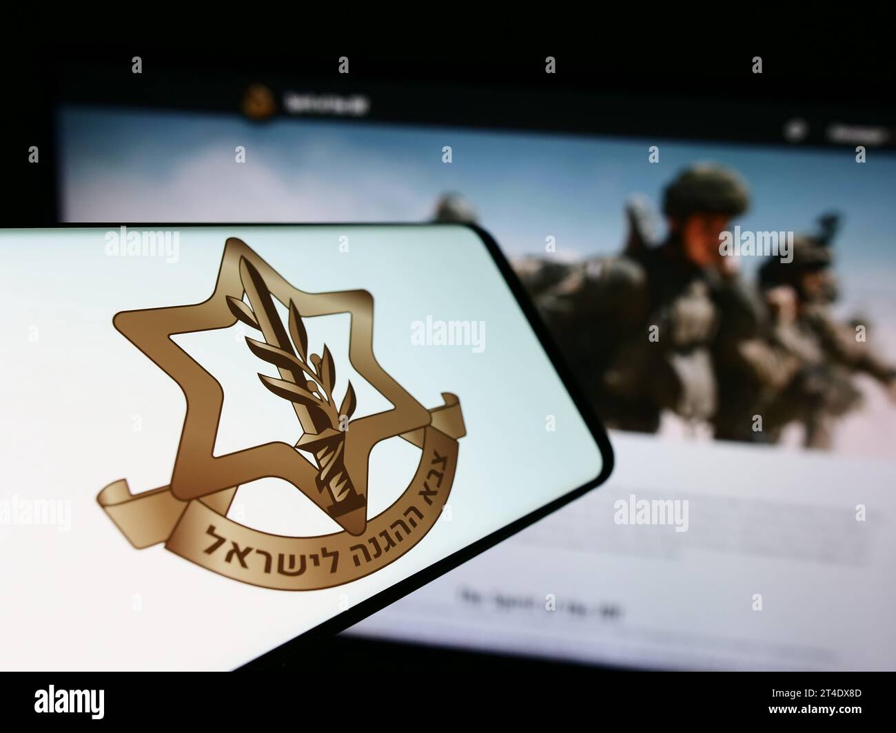 Smartphone with logo of national military Israel Defense Forces (IDF) in front of website. Focus on center-left of phone display. Stock Photo