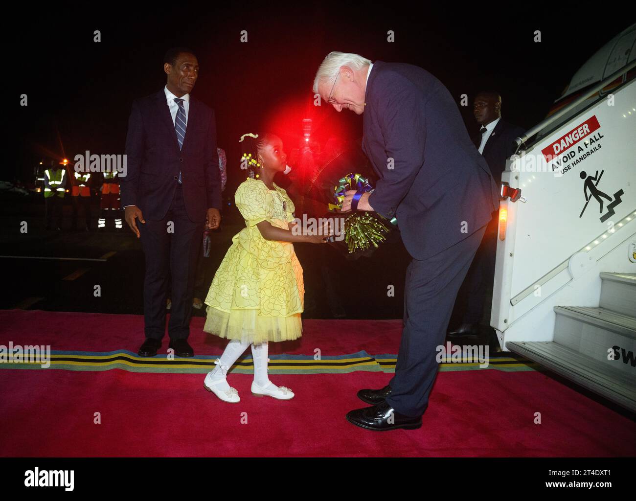 Daressalam, Tanzania. 30th Oct, 2023. German President Frank-Walter Steinmeier is greeted with flowers by a girl at Julius Nyerere International Airport in Dar es Salaam. President Steinmeier is visiting the East African countries of Tanzania and Zambia this week. Credit: Bernd von Jutrczenka/dpa/Alamy Live News Stock Photo