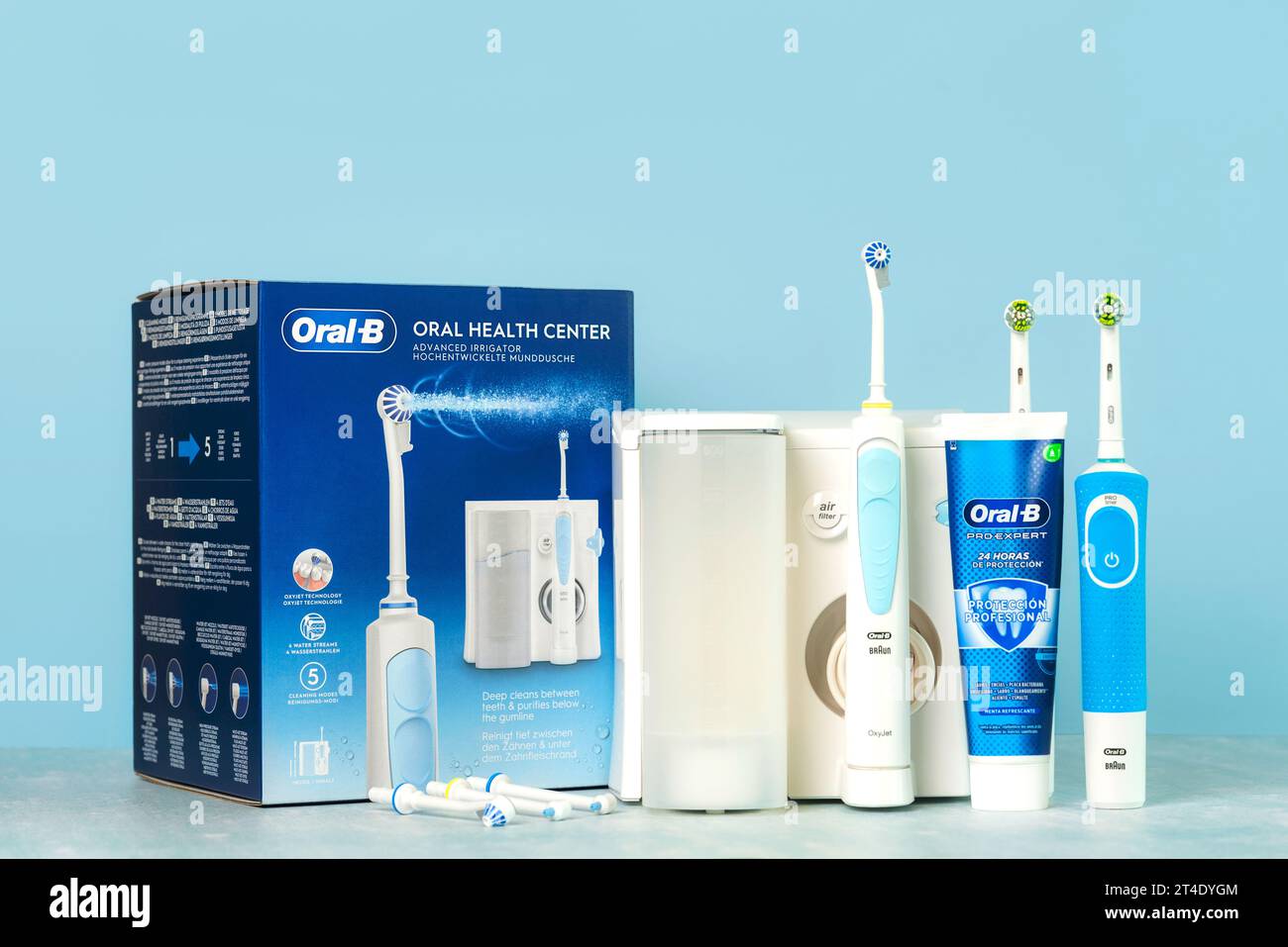 Oral health center irrigator Oral-B,electric toothbrushes Oral-B Vitality and Oral B toothpaste on a blue table Stock Photo