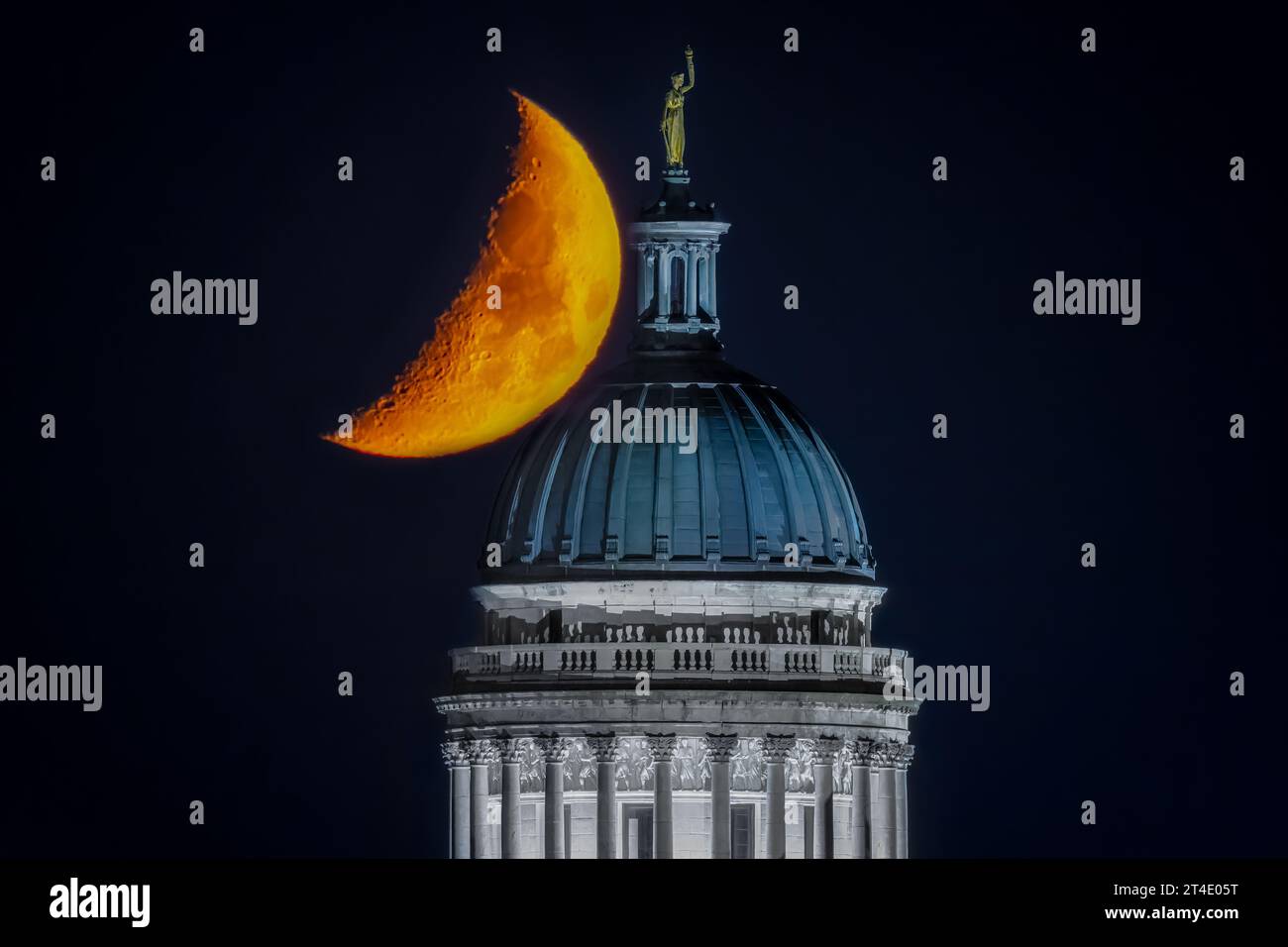 Bergen Courthouse Moon - The waxing crescent moon seems to lean on the Beaux Arts architectural style dome  of the Bergen County Courthouse. Stock Photo
