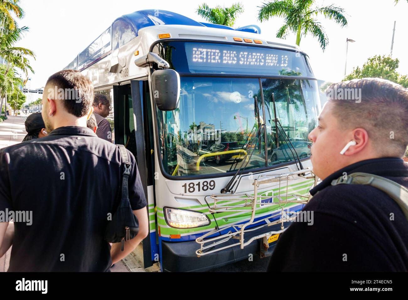 Miami Beach Florida,Collins Avenue,Miami-Dade Metrobus public bus transportation,boarding riders passengers,man men male,adult,resident,Hispanic Latin Stock Photo