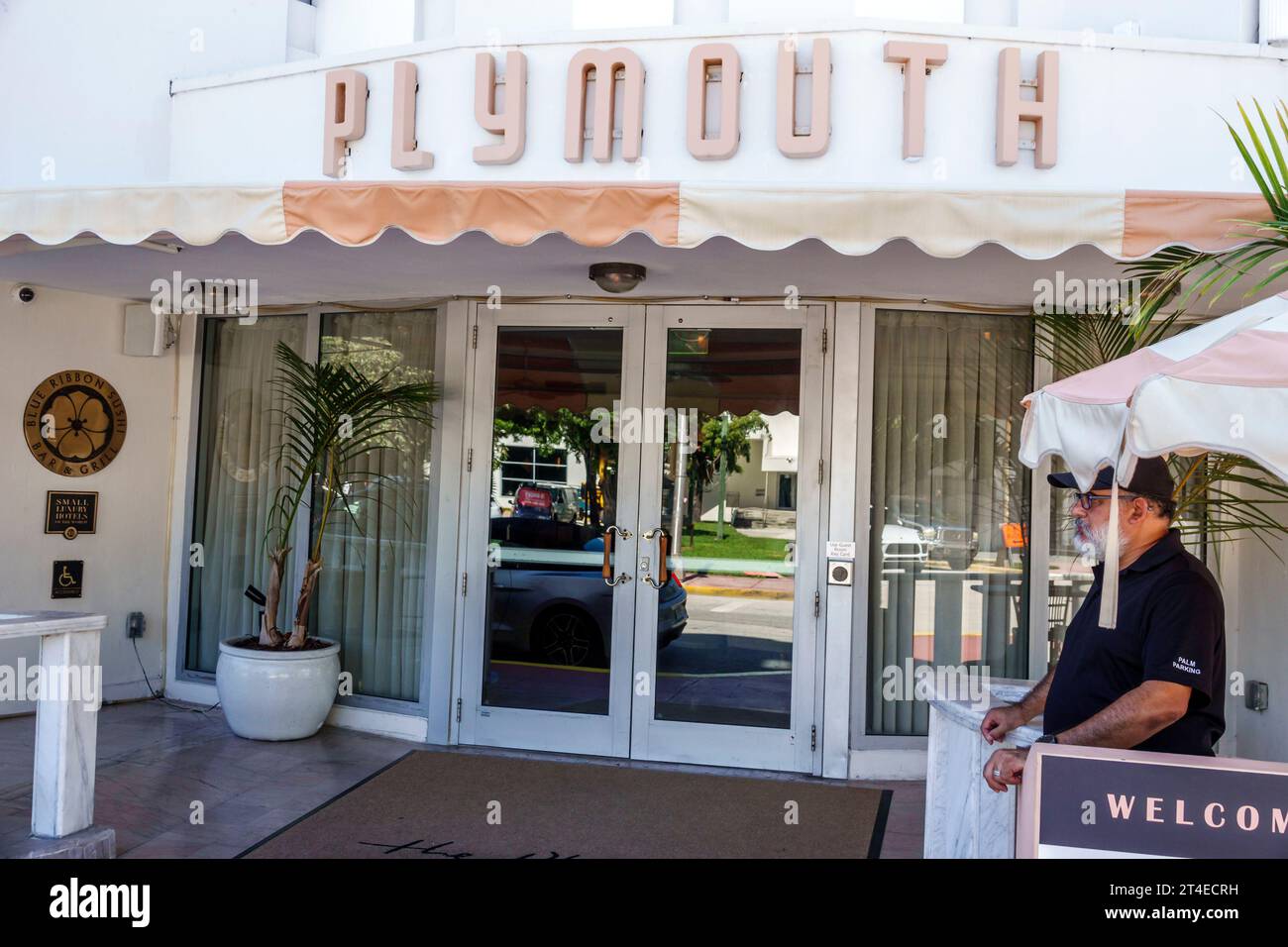 Miami Beach Florida,outside exterior,building front entrance hotel,The Plymouth South Beach sign,man men male,adult,resident,valet,Hispanic Latin Lati Stock Photo