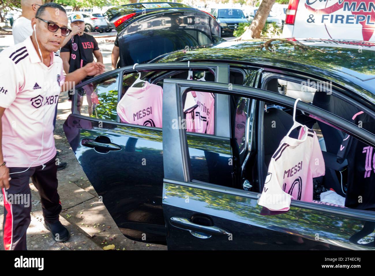 Miami Beach Florida,North Beach parking lot car park,selling Messi soccer football futbol shirts from out of car,man men male,adult,resident,street ve Stock Photo