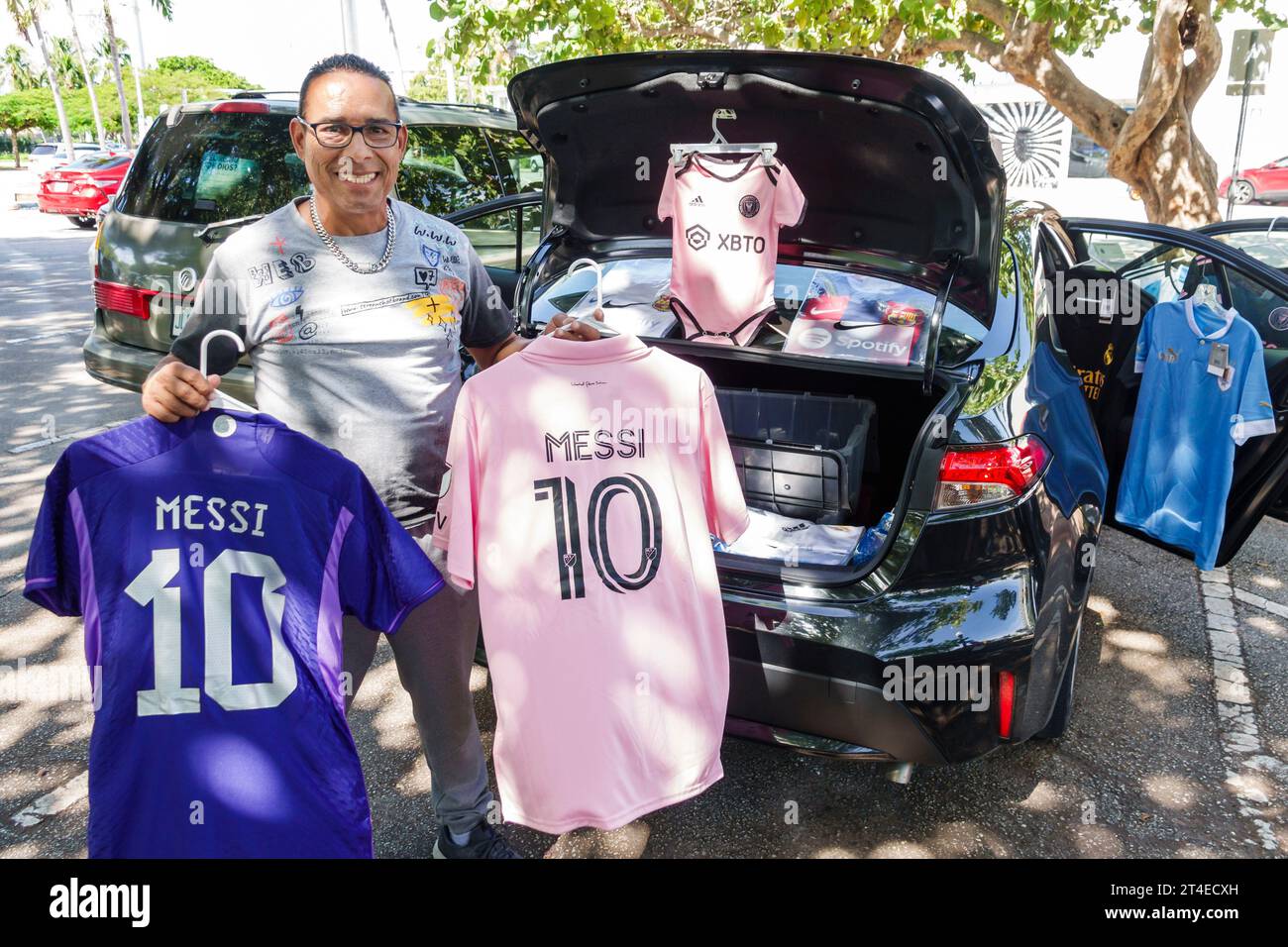 Miami Beach Florida,North Beach parking lot car park,selling Messi soccer football futbol shirts from out of car,man men male,adult,resident,street ve Stock Photo