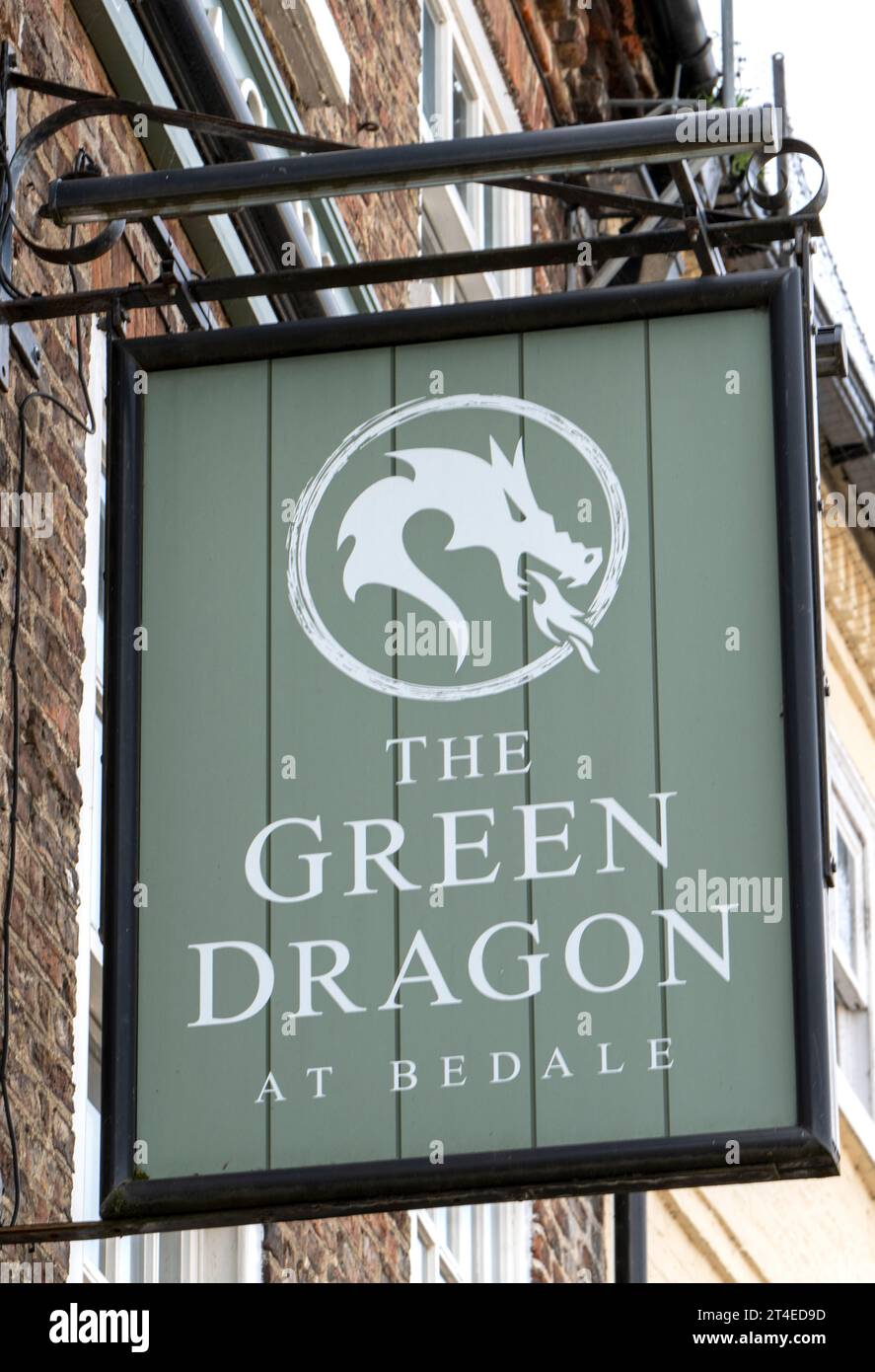 Traditional hanging pub sign at The Green Dragon public house, Market Place, Bedale, North Yorkshire, England, UK. Stock Photo
