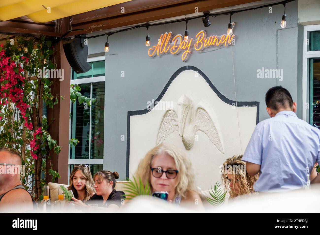 Miami Beach Florida,outside exterior,building front entrance hotel,Ocean Drive Cafe Americano all day brunch neon sign,man men male,woman women lady f Stock Photo