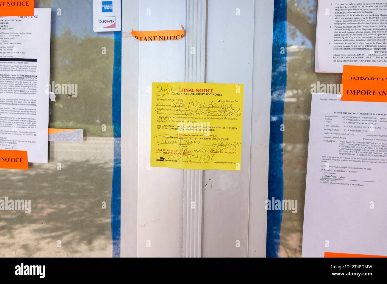 Miami Beach Florida,outside exterior,building front entrance hostel,closed empty vacated,deputy tax collector's levy notice,code violations Stock Photo
