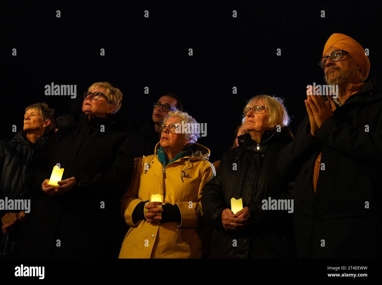 People attend a candlelit Vigil of solidarity for peace in the Middle