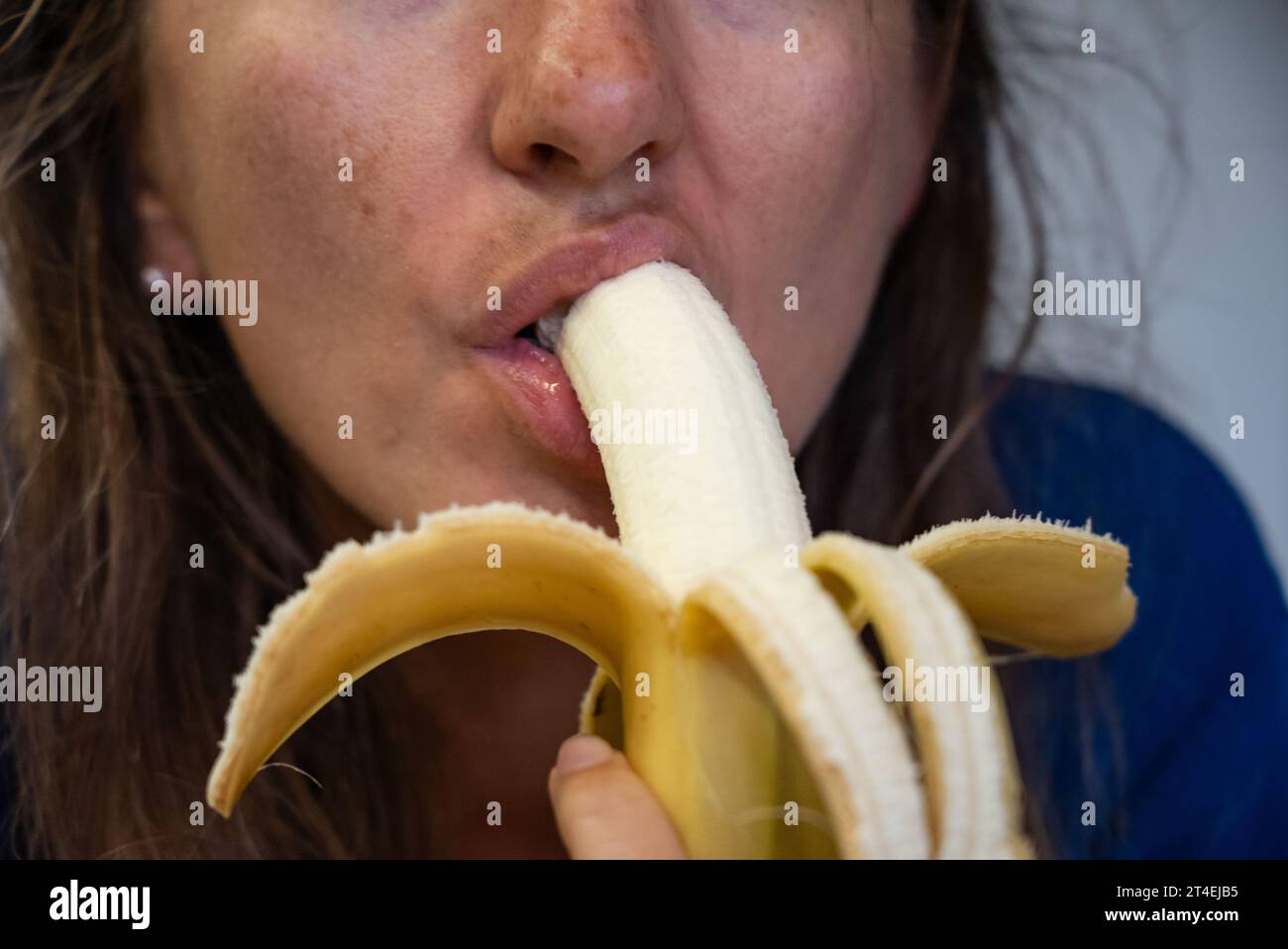 Woman eats food. Woman eats banana. Close shot of girl eating bananas