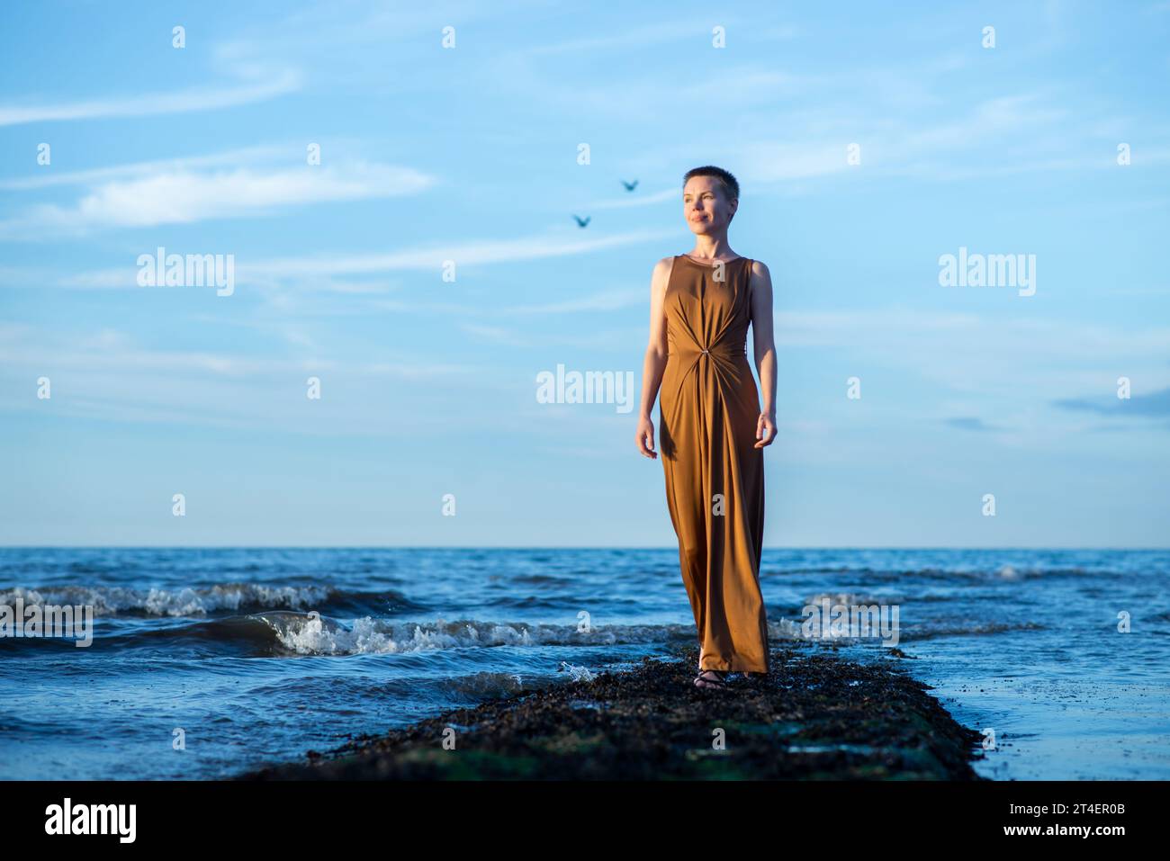 short hair maxi dress Woman with Short Hair in Beautiful Long Dress Stock Photo