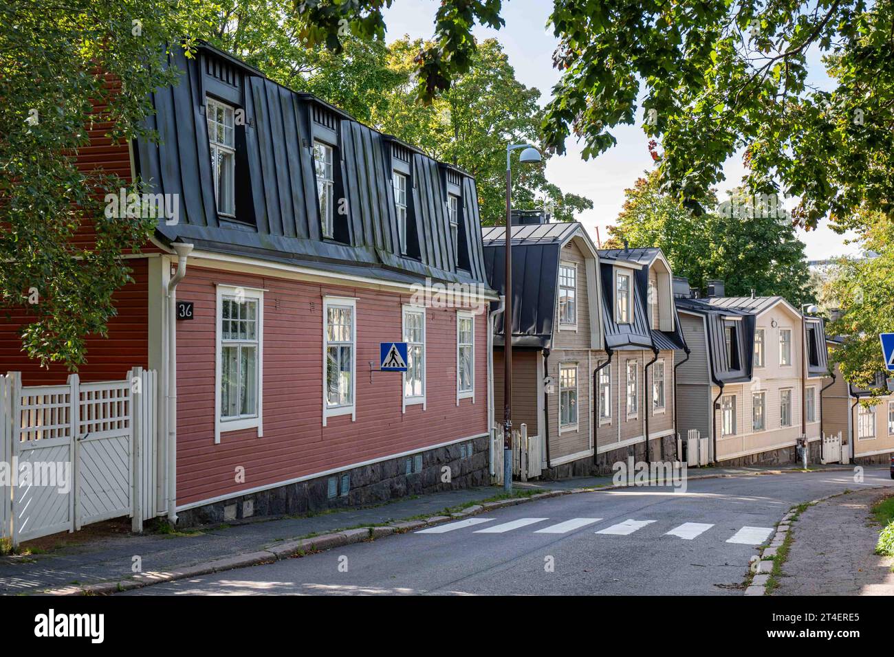 Old wooden residential buildings on Vallilantie downhill street in Puu-Vallila district of Helsinki, Finland Stock Photo