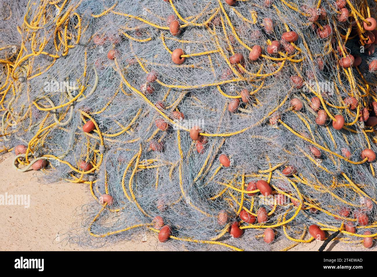 Pile of fishing net drying on the shore, closeup still lige background Stock Photo