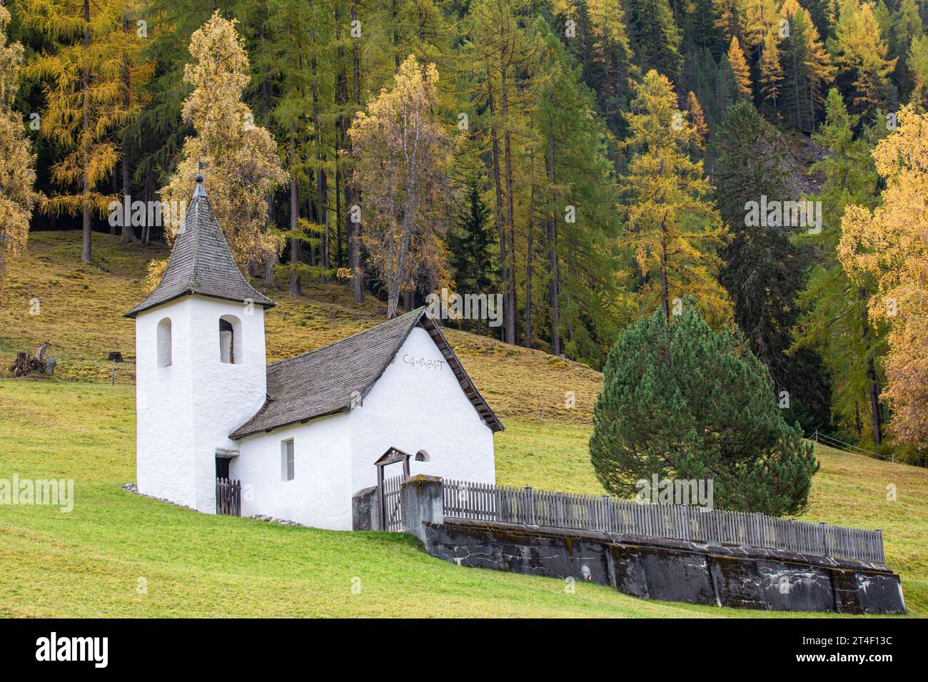 Small church in the autumn Alps. Amazing landscape with small chapel on meadow at Jenisberg, Davos Wiesen, Davos, Switzerland Stock Photo