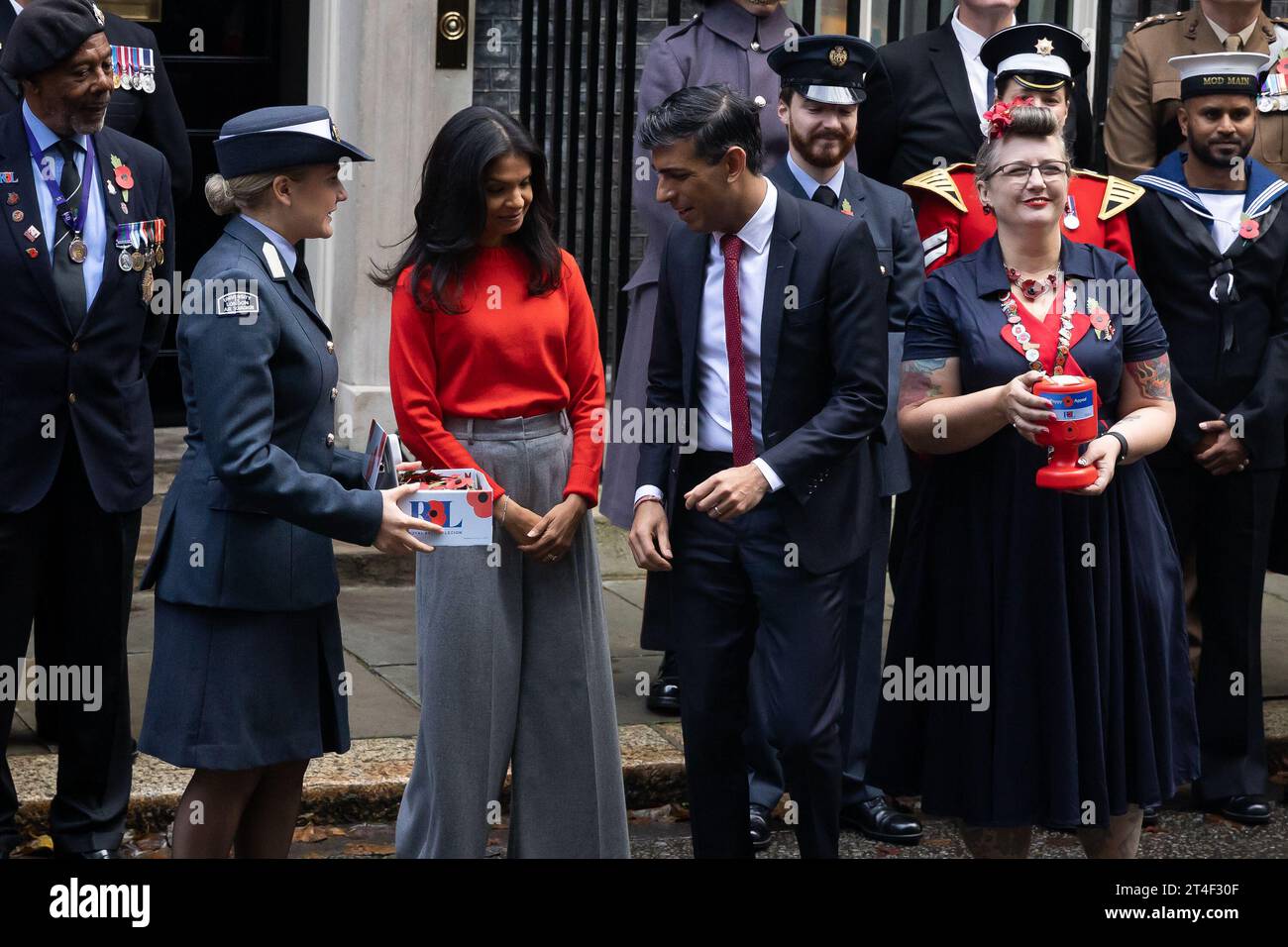 London, UK. 30th Oct, 2023. British Prime Minister Rishi Sunak and wife Akshata Murthy pose with fundraisers from The Royal British Legion's Poppy Appeal after purchasing his own poppy in Downing Street in London. Credit: SOPA Images Limited/Alamy Live News Stock Photo