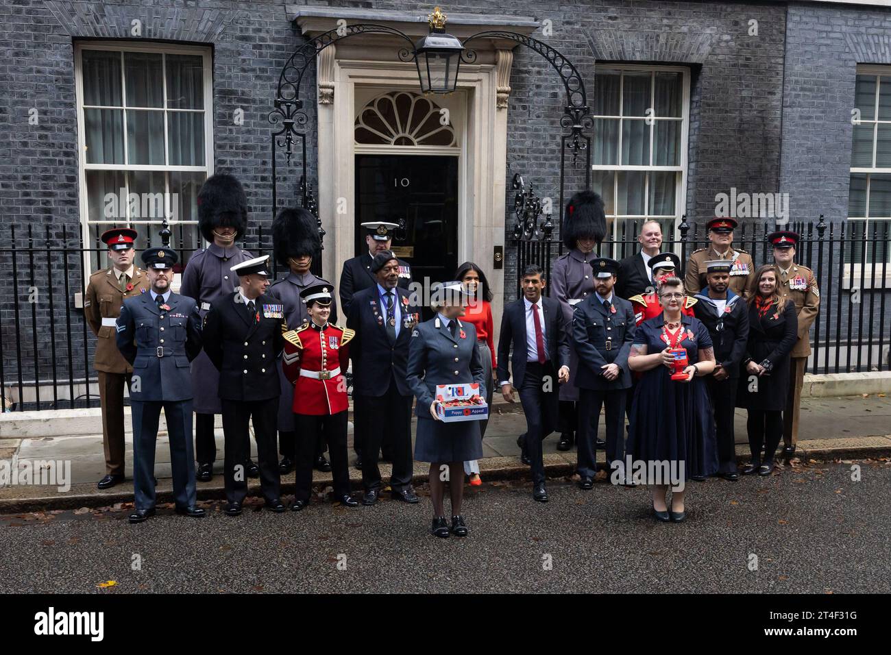 London, UK. 30th Oct, 2023. British Prime Minister Rishi Sunak and wife Akshata Murthy pose with fundraisers from The Royal British Legion's Poppy Appeal after purchasing his own poppy in Downing Street in London. Credit: SOPA Images Limited/Alamy Live News Stock Photo