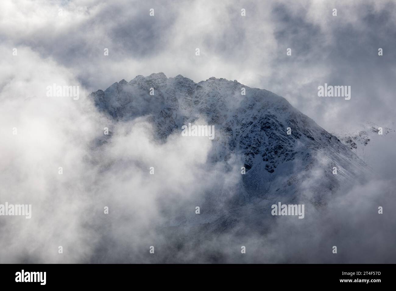 Mountain peak emerge through the misty clouds at swiss alps near Davos, Switzerland Stock Photo