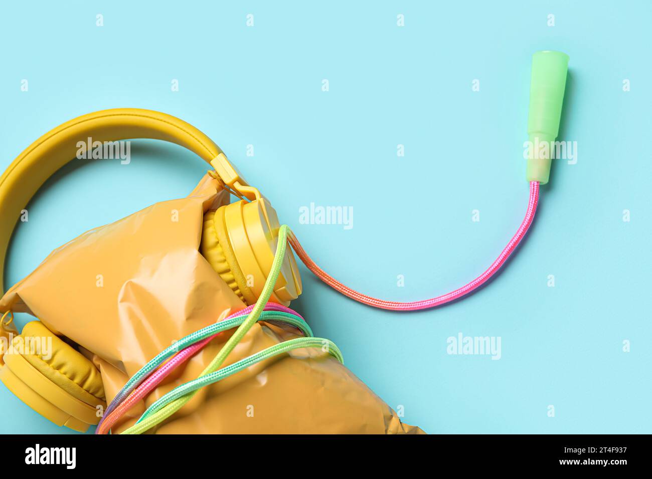 Healthy snack with modern headphones and skipping rope on color ...