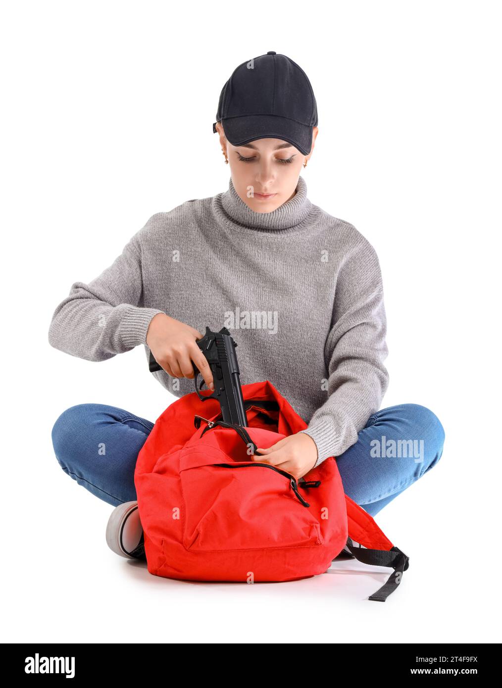 Female student with gun in backpack on white background. School