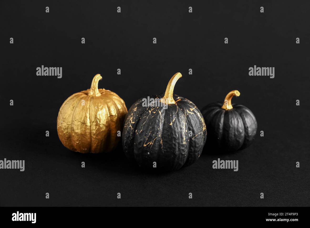 Painted pumpkins on black background Stock Photo - Alamy