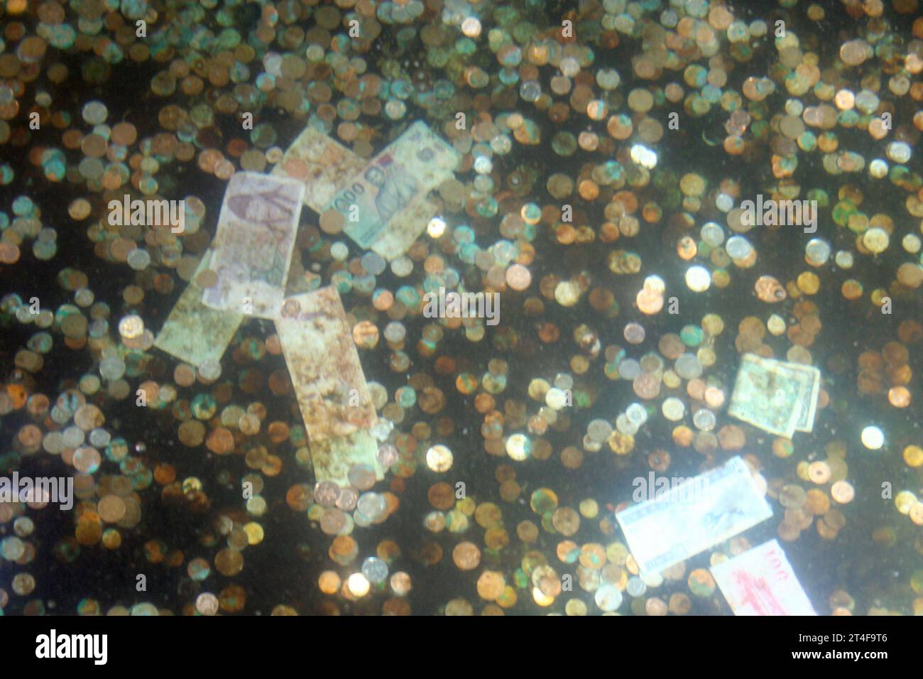 Banknotes and coins at the bottom of the Roman baths of Bath Stock ...