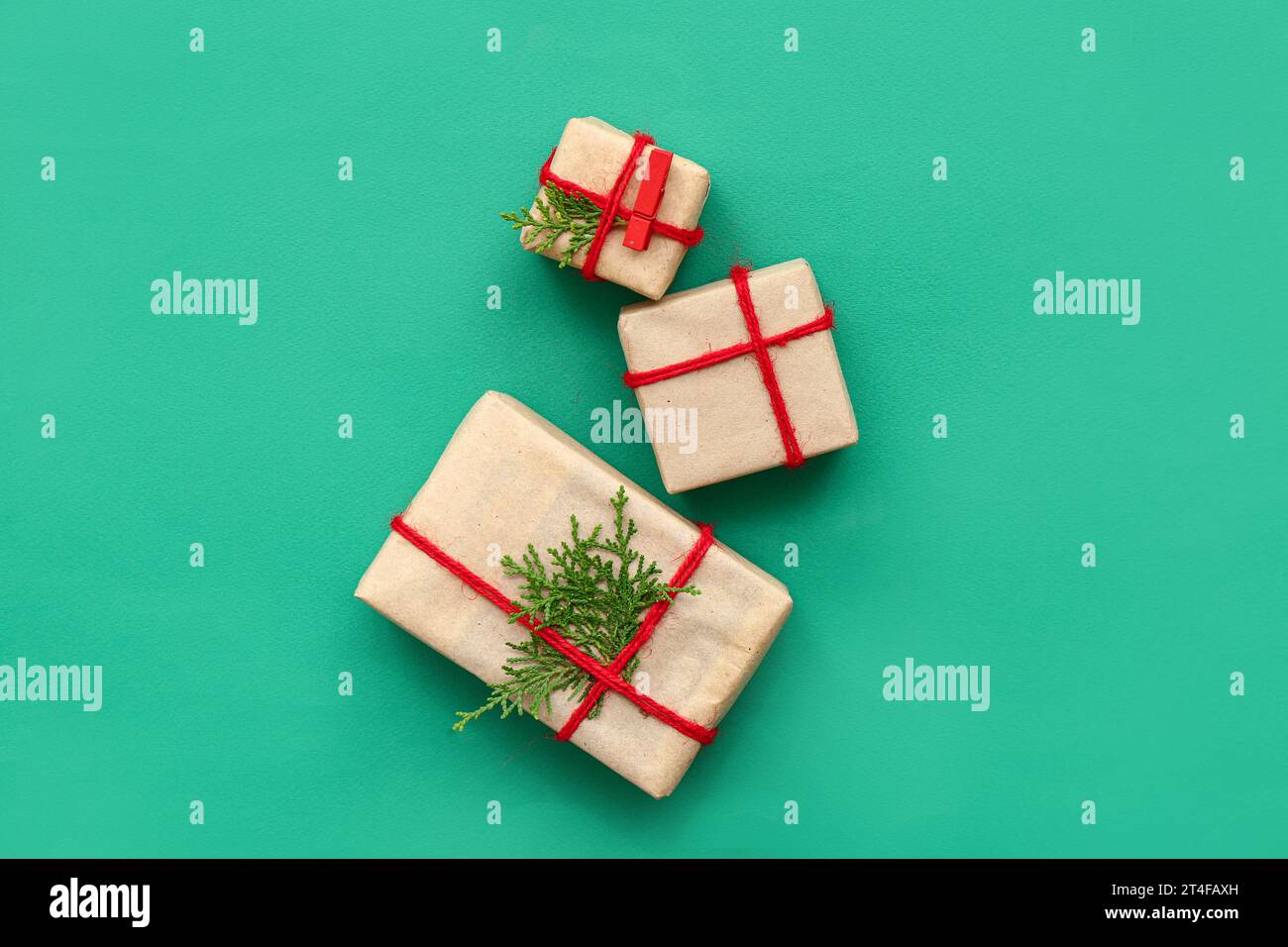 Christmas gift boxes with coniferous branches on green background Stock ...