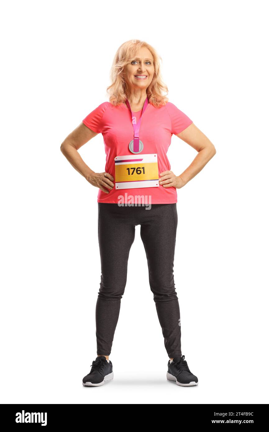 Full length portrait of a woman marathon runner with a race bib and a medal smiling at camera isolated on white background Stock Photo