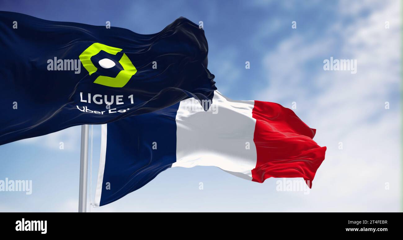 Paris, FR,Oct 15 2023: Ligue 1 and France national flag waving together. French professional league for men association football clubs. Illustrative e Stock Photo