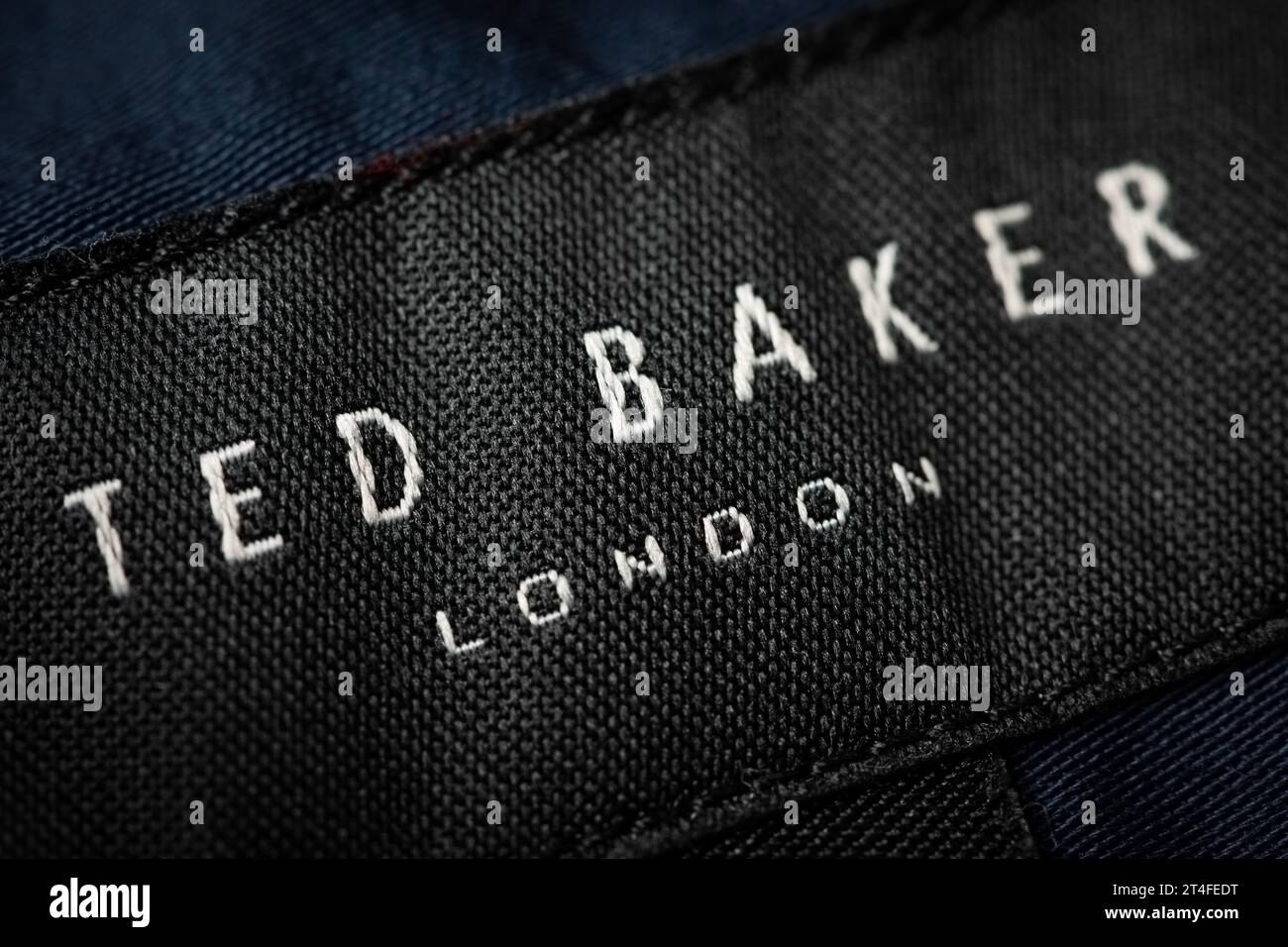 A close-up shot of an embroidered Ted Baker logo as seen on a tag. Stock Photo