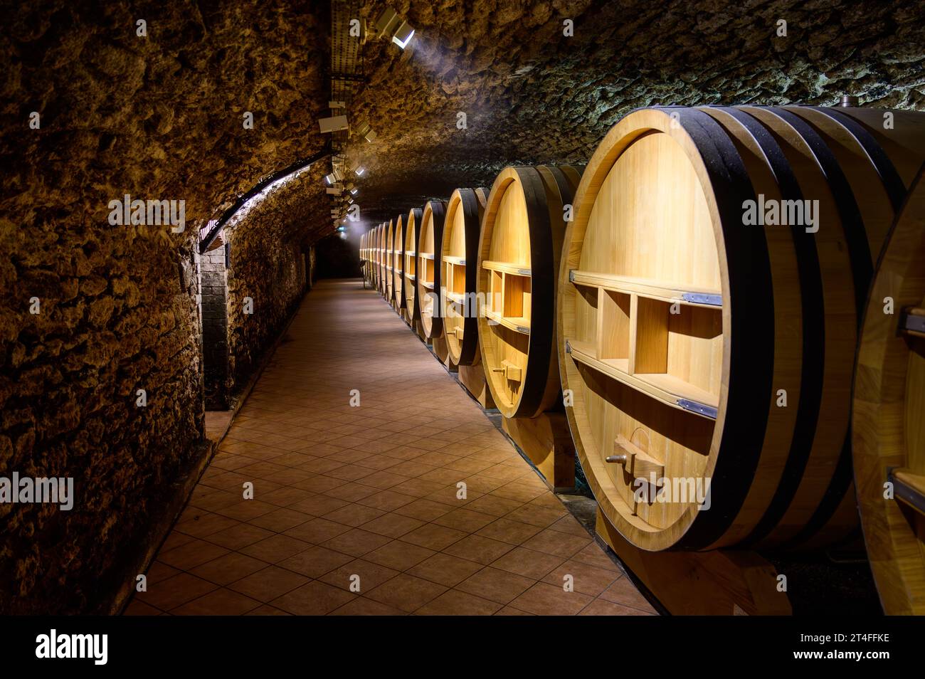 Underground wine cellars with barrels for aging of red dry wine in ChateauneufduPape wine