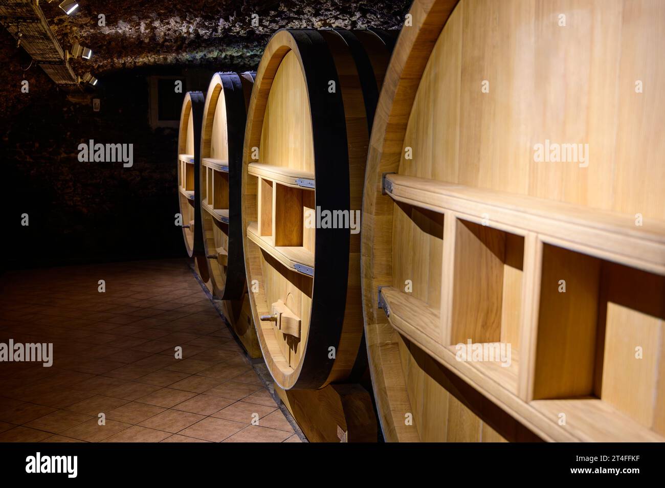 Underground wine cellars with barrels for aging of red dry wine in ChateauneufduPape wine