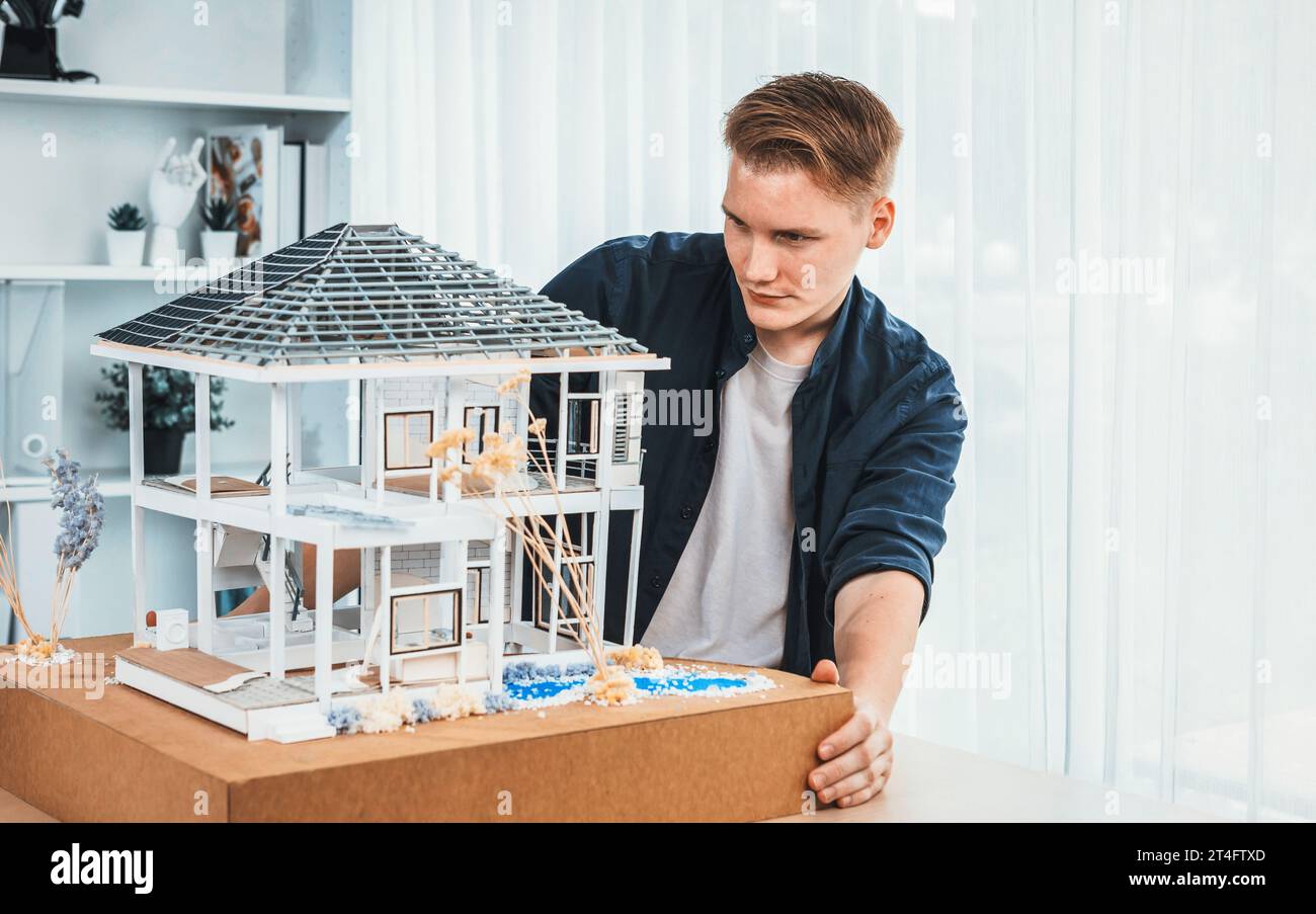 Architect designer reviewing house frame model with no wall, brainstorming interior design and improvement idea with actual home scale. Professional Stock Photo