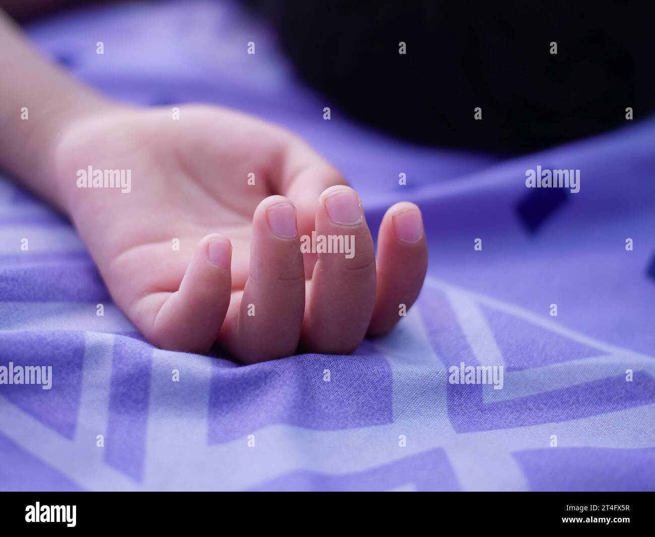 hand of a small child sleeping on his back Stock Photo