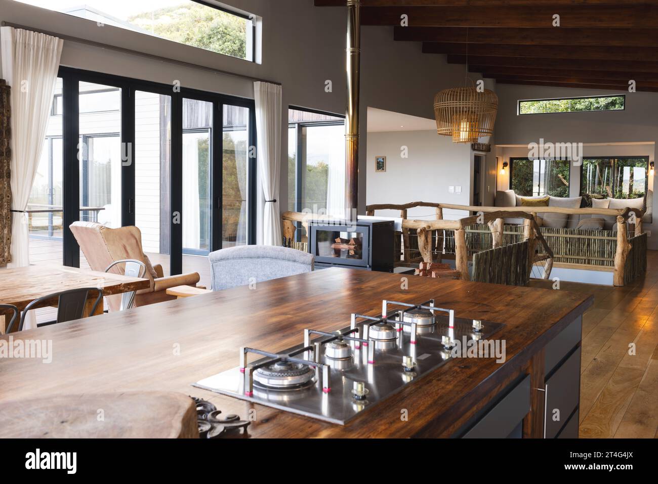 Modern kitchen connected to living room and big windows Stock Photo
