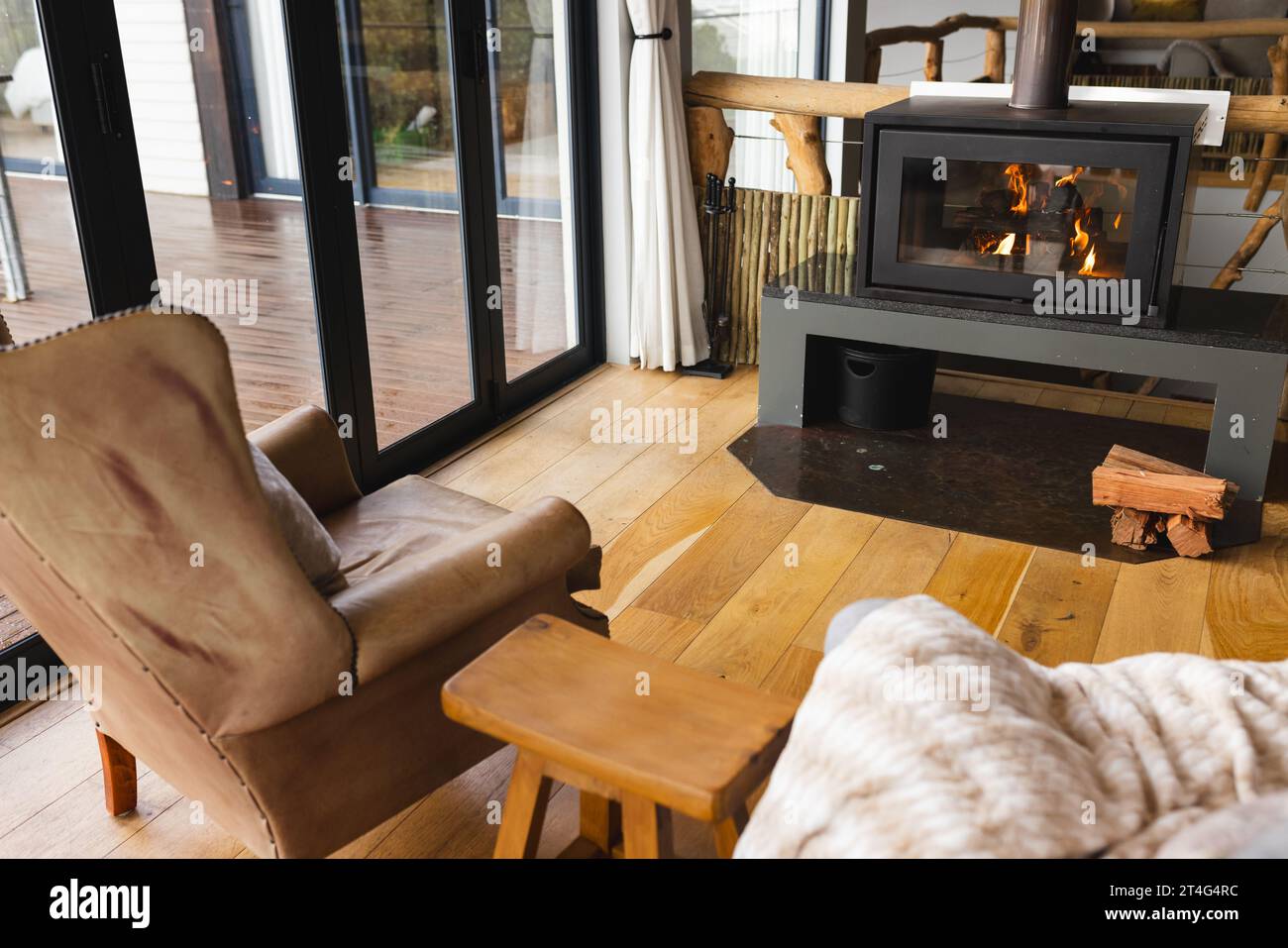 Modern living room with fireplace and big windows Stock Photo