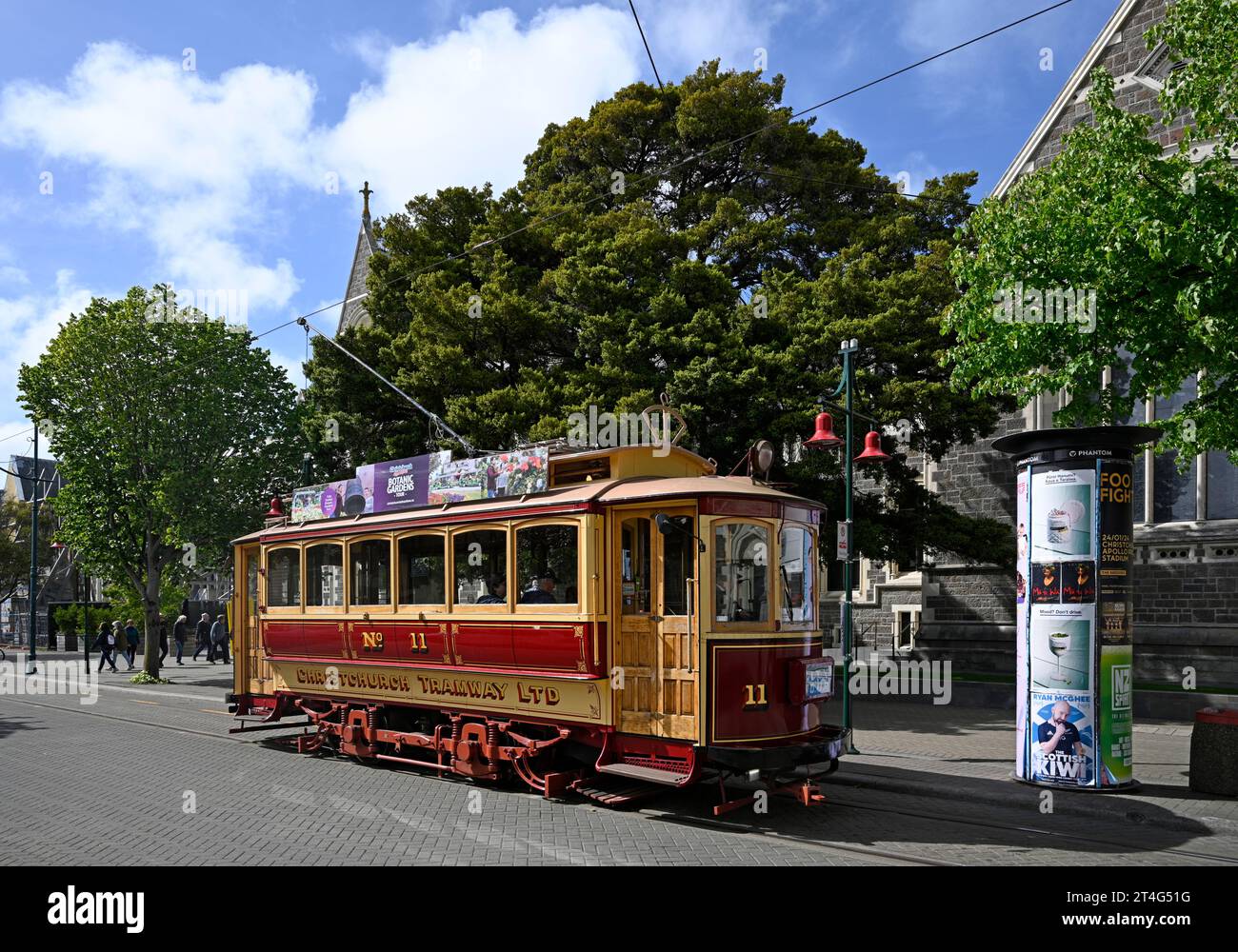 Christchurch, New Zealand - October 30, 2023; Historic Tram outside The Christchurch Arts Centre Clock Tower and Ernest Rutherford Rooms, New Zealand Stock Photo