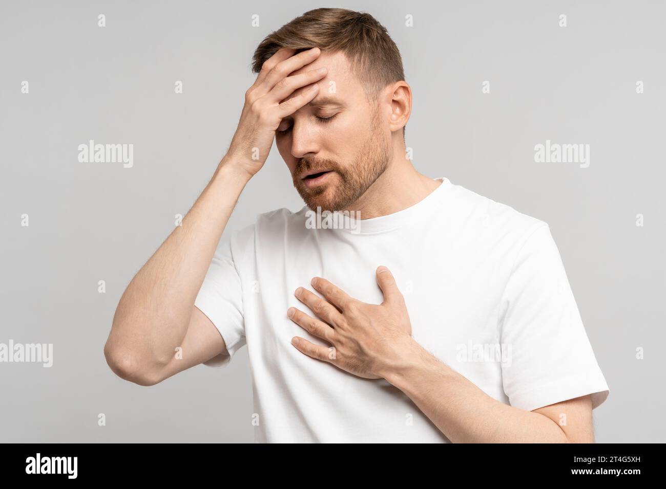 Unwell Man Man touches chest hand hi-res stock photography and images - Alamy