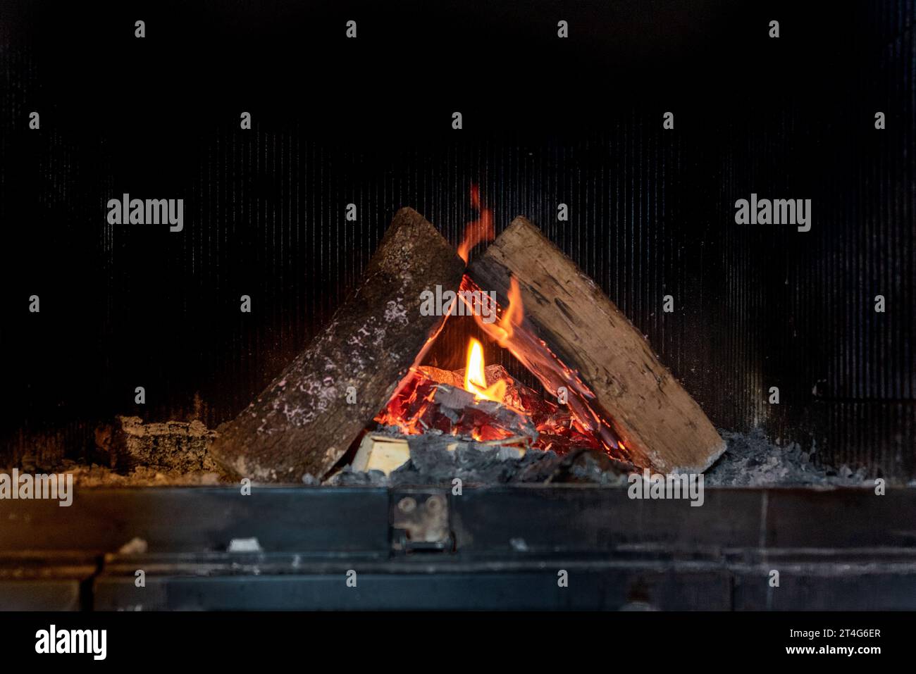 Fire in fireplace with burning flames. Stock Photo