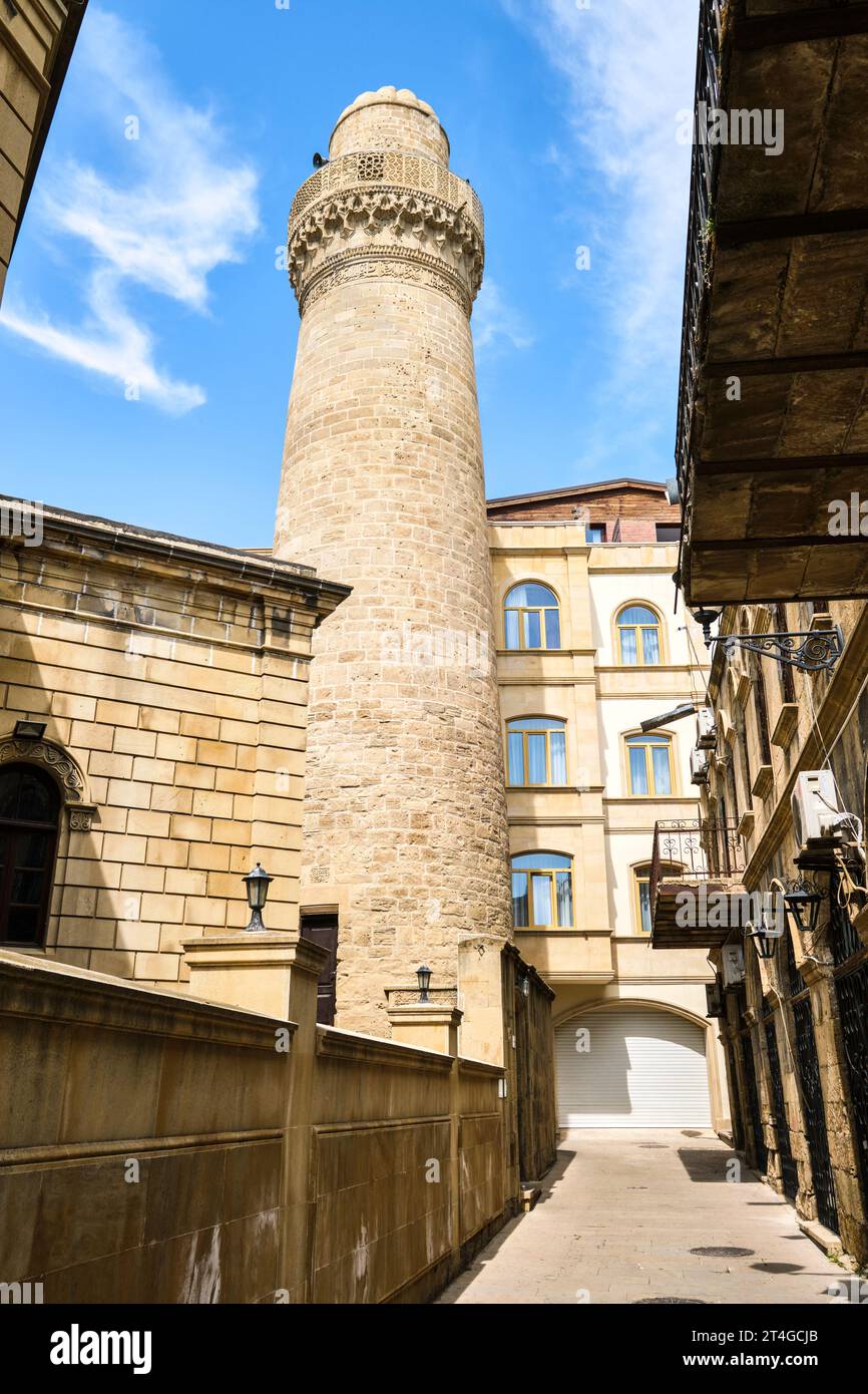 A view of the historic, Muslim, Juma (Friday) Mosque with tall, round, stone minaret. In the Old City section of Baku, Azerbaijan. Stock Photo