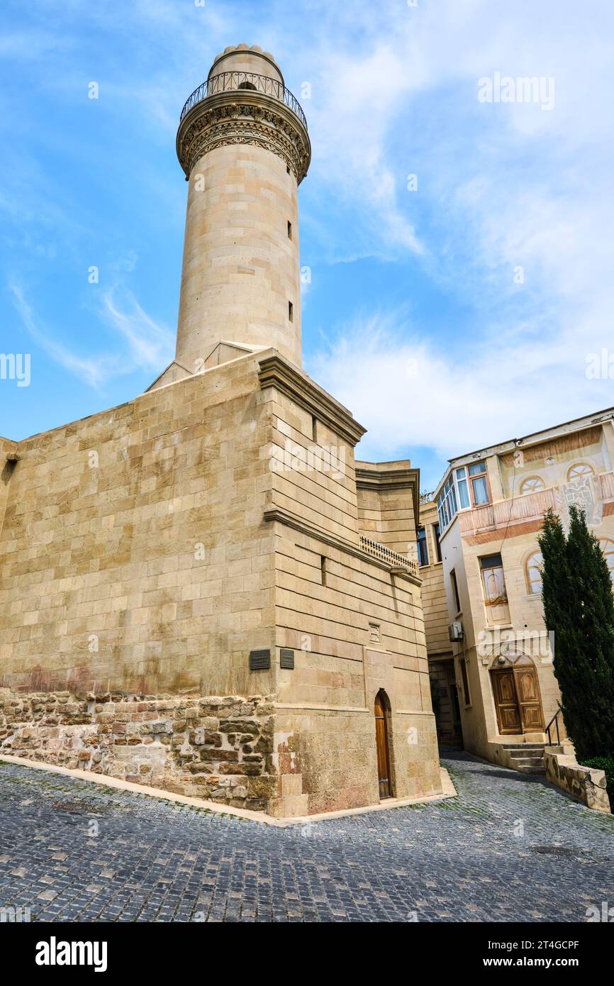 A view of the historic Muslim Bayar Mosque and its tall, round, circular stone minaret. In the Old City section of Baku, Azerbaijan. Stock Photo