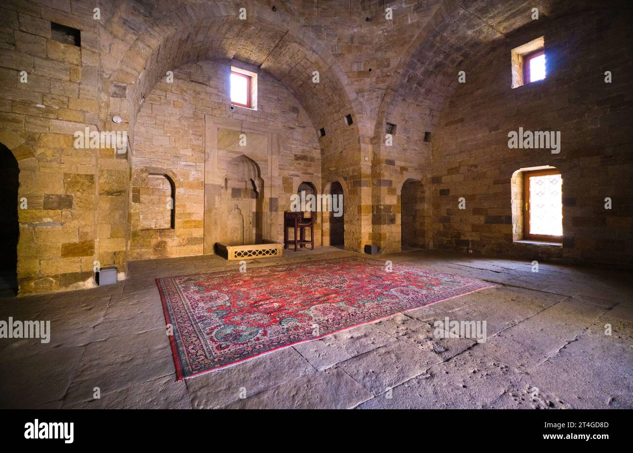 Interior view of the Shah Mosque, Şah Məscidi with red rug, carpet. At the Palace of the Shirvanshahs complex in the Old City section of Baku, Azerbai Stock Photo