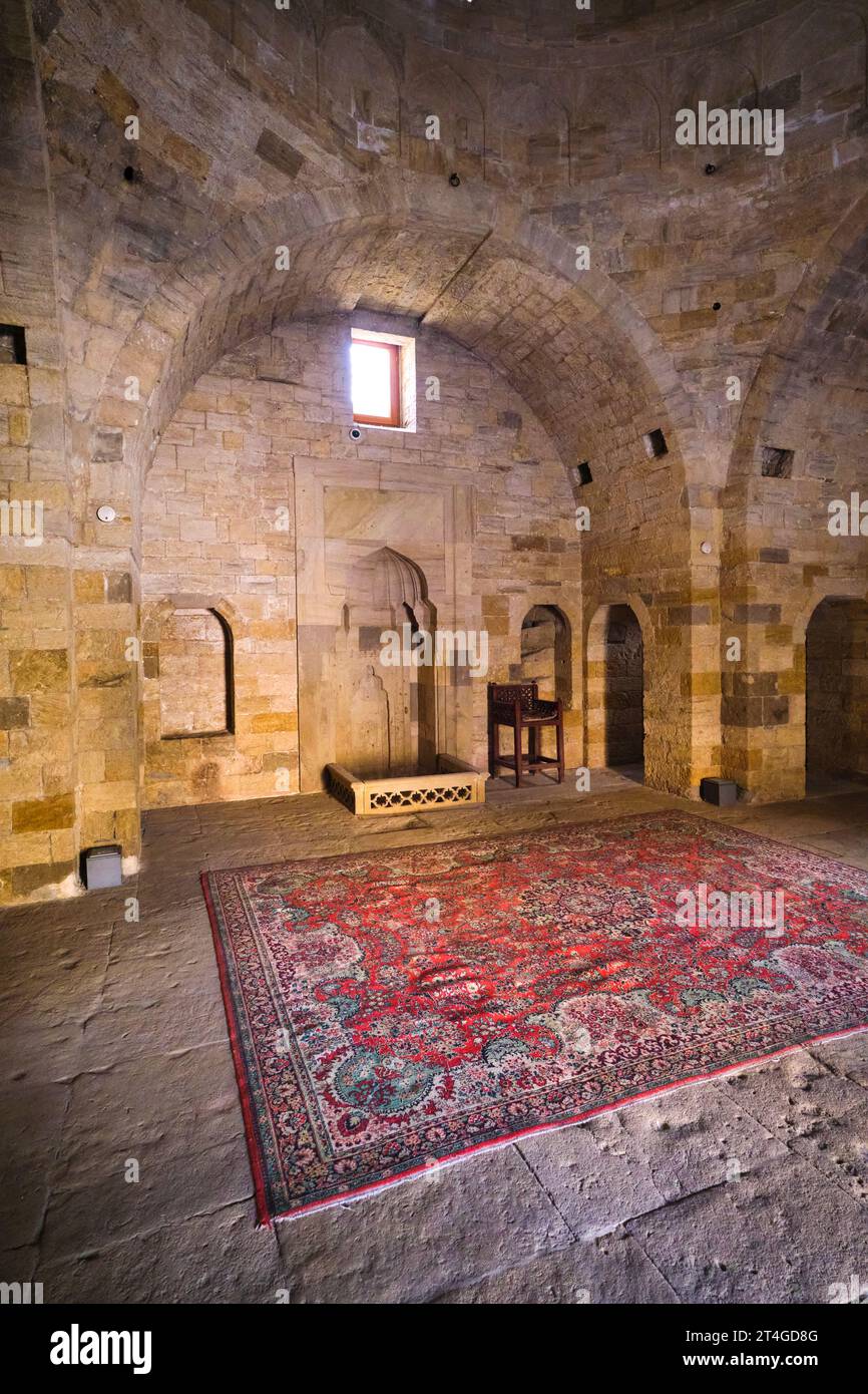 Interior view of the Shah Mosque, Şah Məscidi with red rug, carpet. At the Palace of the Shirvanshahs complex in the Old City section of Baku, Azerbai Stock Photo