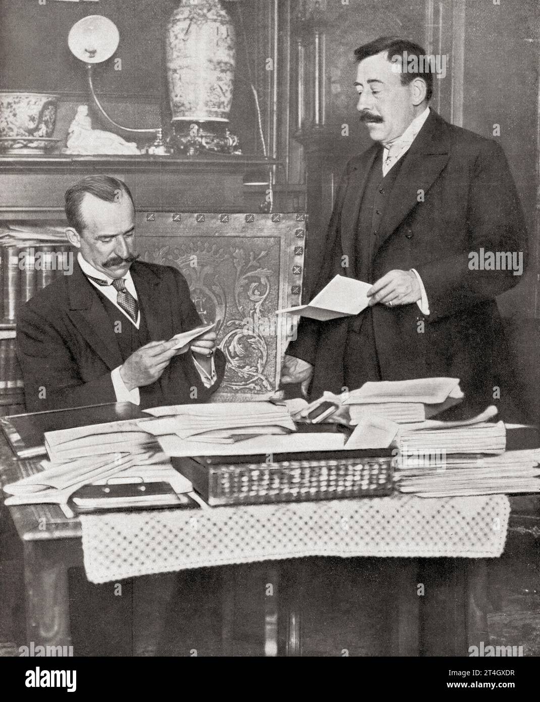 Álvaro de Figueroa y Torres-Sotomayor, 1st Count of Romanones, 1863 – 1950. Spanish politician, businessman and three times Prime Minister of Spain. Seen here on the left, in his office with his secretary Señor Brocas. From Mundo Grafico, published 1912. Stock Photo