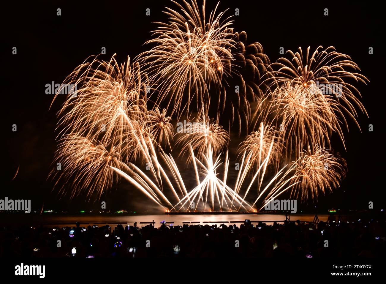Joyful moment of people capturing fireworks show with camera and smart phone. Pattaya fireworks festtval. Stock Photo