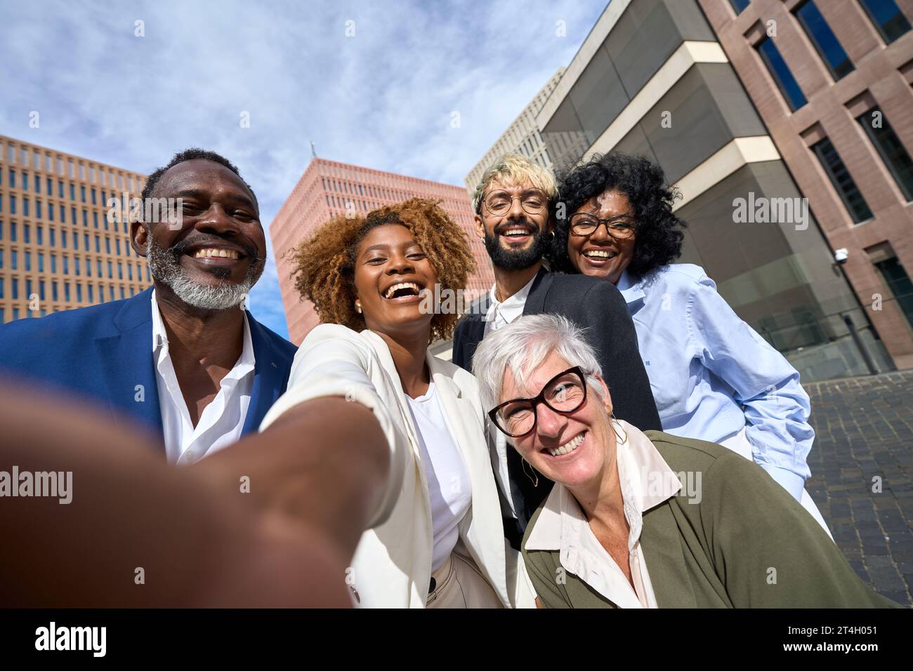 Happy multi-ethnic colleagues taking a selfie outdoors Stock Photo