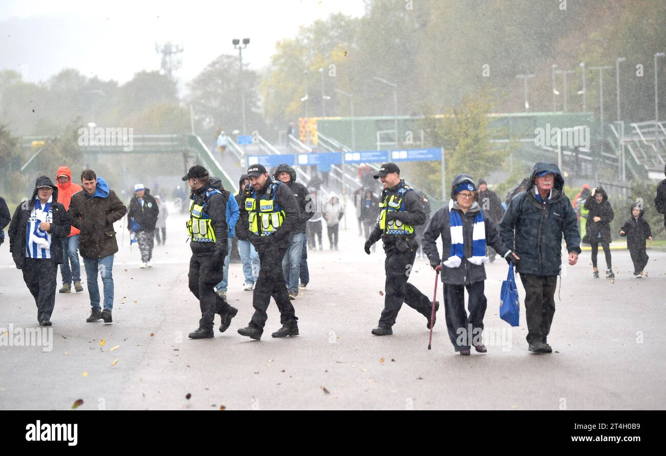 Fans and police get caught in the wind and torrential rain before the Premier League match between Brighton and Hove Albion and Fulham at the American Express Stadium  , Brighton , UK - 29th October 2023 Photo Simon Dack / Telephoto Images. Editorial use only. No merchandising. For Football images FA and Premier League restrictions apply inc. no internet/mobile usage without FAPL license - for details contact Football Dataco Stock Photo