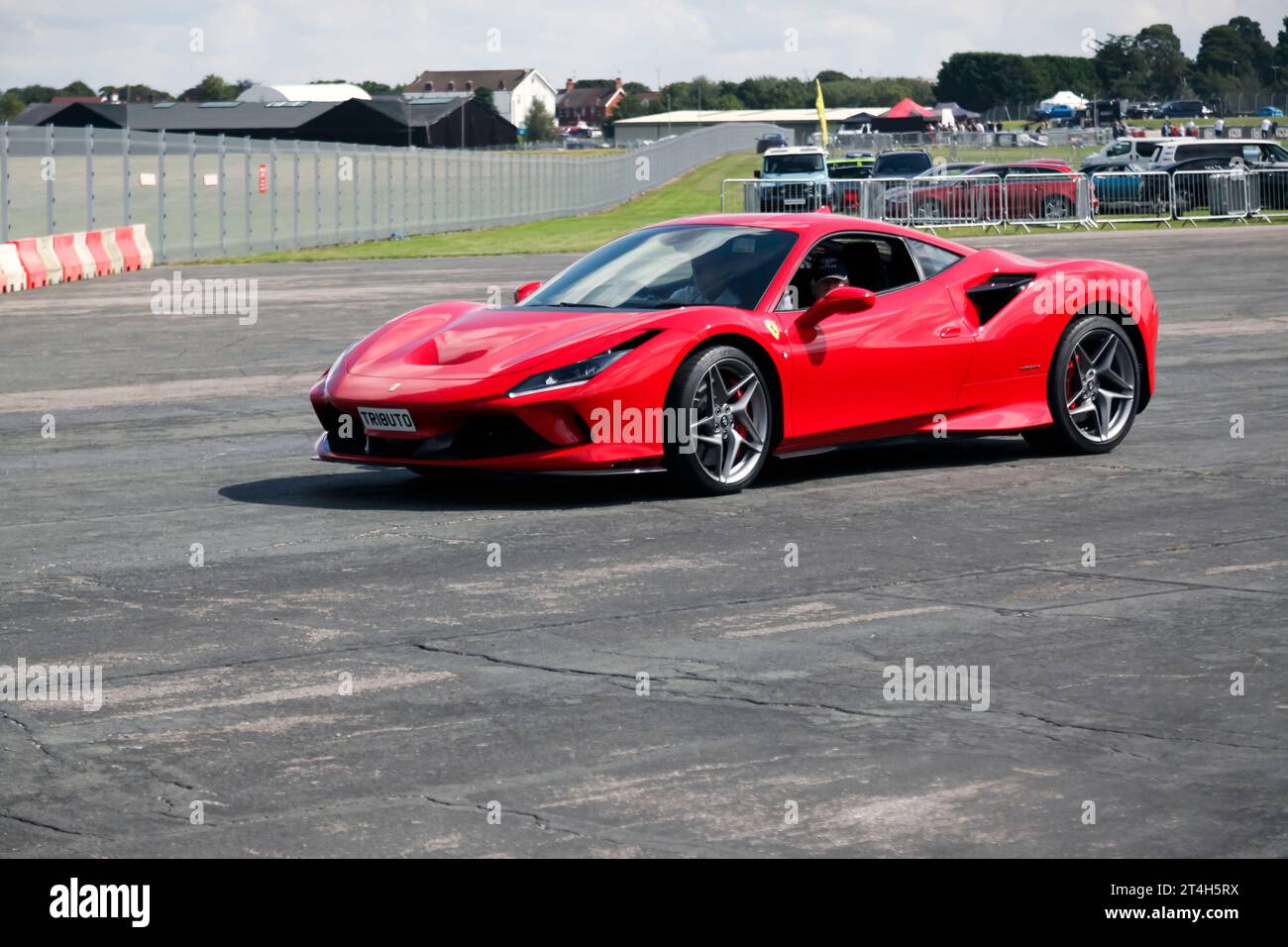 Three-quarters Front View of a 2020, Red, Ferrari F8 Tributo, exiting the live arena, after the Super Car Showdown, at the 2023 British Motor Show Stock Photo