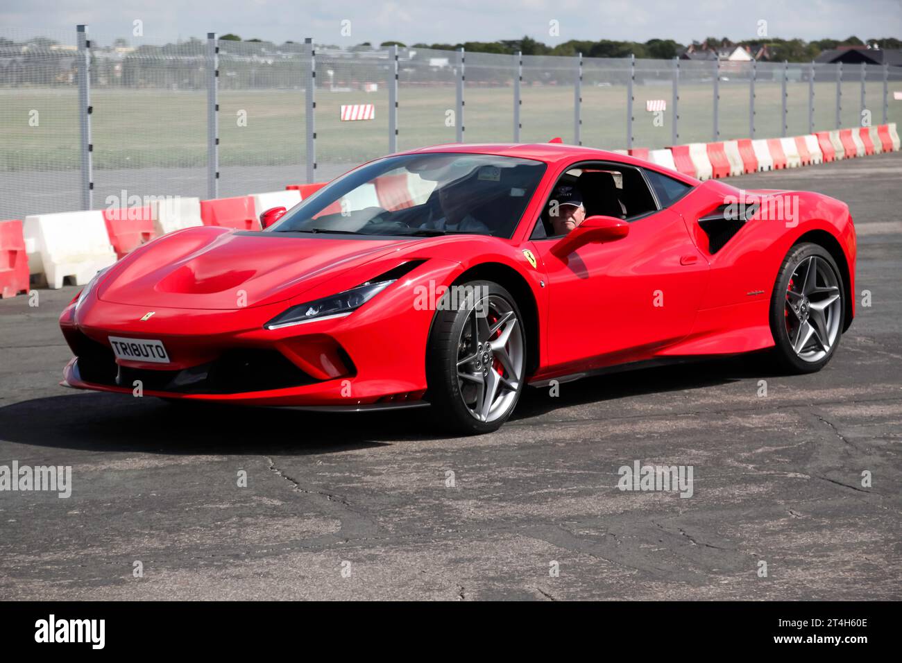 Three-quarters Front View of a 2020, Red, Ferrari F8 Tributo, exiting the live arena, after the Super Car Showdown, at the 2023 British Motor Show Stock Photo